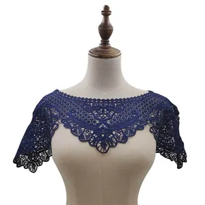 Detail view of navy blue lace shawl with exquisite floral embroidery on mannequin