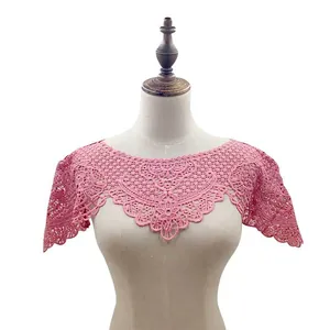 Macro detail of pink hollowed lace embroidery on a hanfu style cloud shoulder collar.