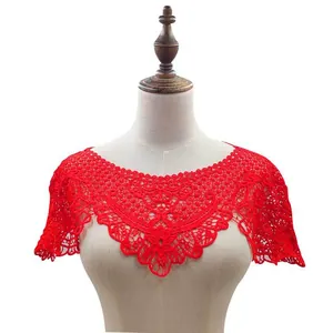 Detailed view of red hollow lace embroidery shawl on a mannequin torso