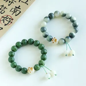 Traditional charred Bodhi bead bracelet featuring cute cat paw charm and engraved mantra
