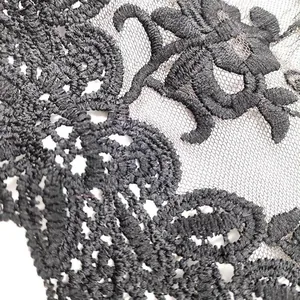 Close-up detail showing the intricate embroidery of black water-soluble lace fabric