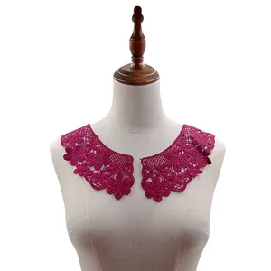 Detailed view of magenta water-soluble lace collar embroidery on a mannequin torso