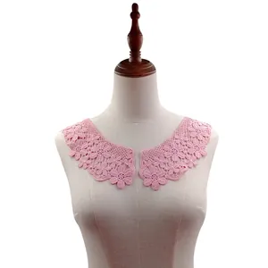 Detail view of a pink water-soluble lace collar with delicate floral embroidery on mannequin.