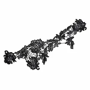 Macro detail of black water-soluble lace floral applique with intricate hollow embroidery