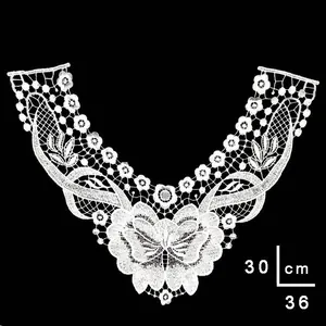 Close-up of white water-soluble lace collar with butterfly embroidery detail