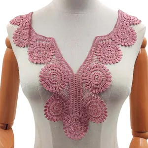 Close-up detail showing the intricate embroidery of the pink water-soluble lace collar