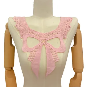 Detailed macro shot of pink milk silk embroidered lace fake collar with elegant bow design