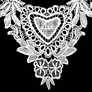 Close-up detail of white guipure lace collar featuring embroidered heart with Love