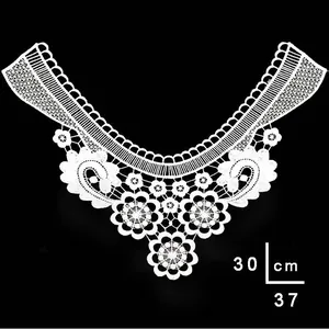 Detailed view of white embroidered lace collar with floral patterns and dimensions
