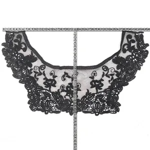 Detailed view of black embroidered lace collar with measurements shown by rulers