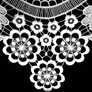 Detailed close-up of white water-soluble embroidered lace collar showing flower patterns