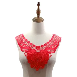 Detailed view of a vibrant red embroidered lace floral collar displayed on a mannequin