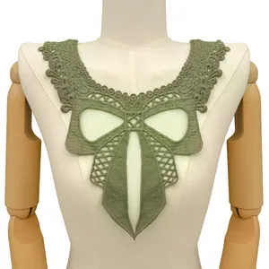 Macro detail of a 3D hollow bow embroidered lace collar patch in sage green color