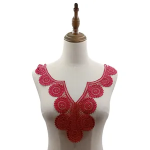 Detailed macro view of red water-soluble lace collar applique on a mannequin