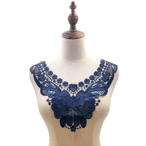 Dark blue water-soluble lace collar applique displayed on a dress form mannequin
