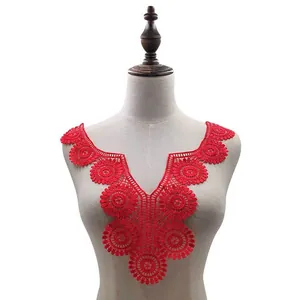 Detailed view of a red floral water-soluble lace collar applique on a mannequin.