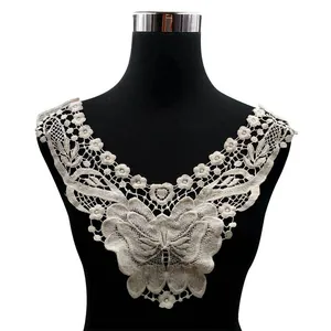 Detailed view of beige water-soluble lace collar with butterfly and floral embroidery