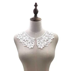 Detail view of white water-soluble milk silk embroidered lace collar on a dress form