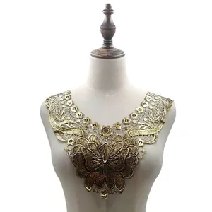 Detailed view of golden water-soluble lace collar with 3D butterfly embroidery on mannequin.