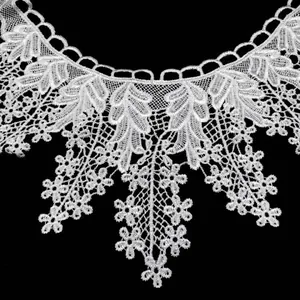 Close-up of white water-soluble lace collar with delicate embroidery patterns