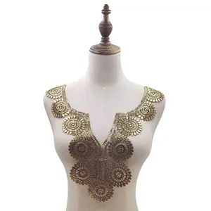 Detailed macro view of gold water-soluble embroidered lace collar applique for DIY sewing