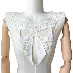 Detailed close-up of a white milk silk embroidered lace collar with a hollow bow design