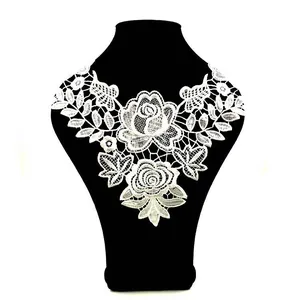 Detailed view of white water-soluble lace collar featuring delicate rose embroidery patterns