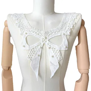 Detailed view of white milk silk embroidered lace collar with pearl butterfly bow