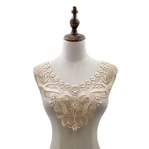 Detail view of intricate water-soluble butterfly lace collar on a mannequin torso