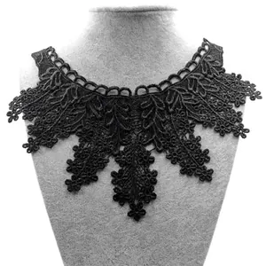 Close-up of black water-soluble lace collar embroidery on display mannequin bust.