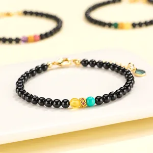 Handmade black agate beaded bracelet with yellow beeswax and turquoise stone accents