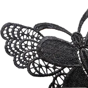 Detailed close-up of a black water-soluble butterfly lace embroidery sewing applique