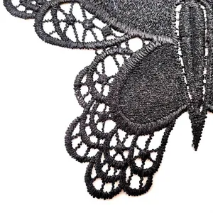 Close-up macro view of intricate black lace butterfly embroidery patch details