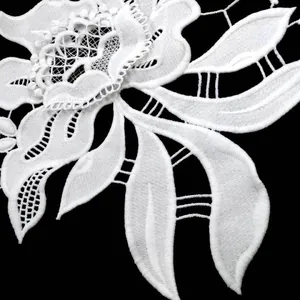 Detailed macro view of white 3D milk silk water-soluble embroidery lace pattern.
