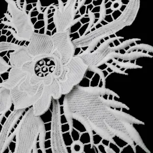 Detailed macro view of 3D white milk silk water-soluble floral lace embroidery trim.