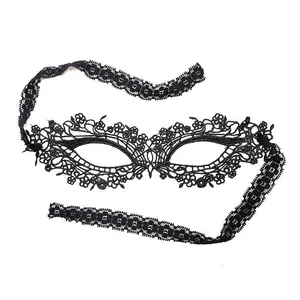 Macro view of a black water-soluble lace masquerade mask with elegant floral hollow patterns.
