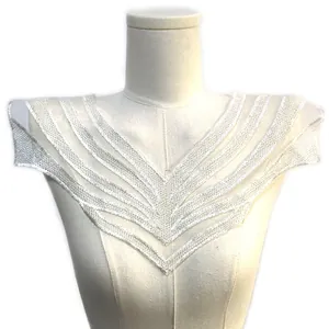 Detailed view of white water-soluble embroidered V-shaped lace collar trim on a mannequin