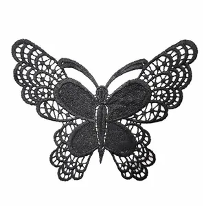 Detailed view of a black water-soluble lace butterfly patch with intricate embroidery