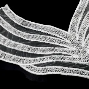 Detailed view of white water-soluble lace collar with intricate polyester embroidery
