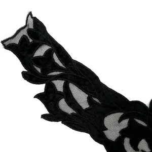 Close-up detail of black water-soluble lace collar with velvet floral embroidery