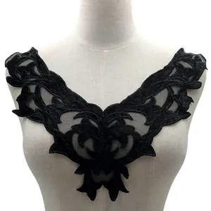 Detailed black lace collar applique with embroidered floral patterns on mannequin