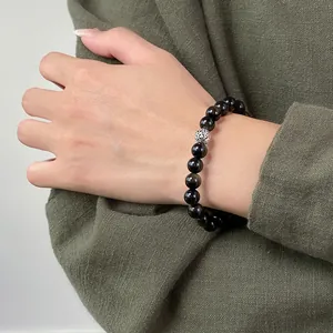 Close-up of S925 sterling silver Thai bead obsidian gemstone bracelet on female wrist