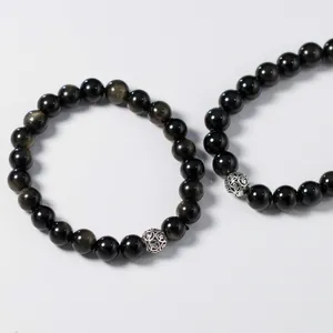 Detail shot of gold sheen obsidian bracelet with S925 Thai silver filigree bead