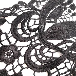 Detailed close-up view of intricate black water-soluble embroidered lace applique texture