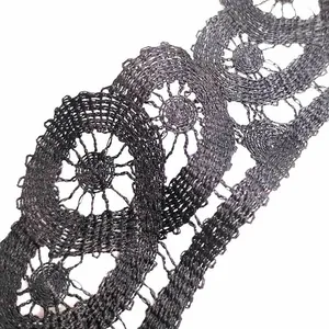 Macro view of black water-soluble embroidery lace featuring a 3D hollow circular design