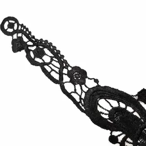 Close-up of black water-soluble lace embroidery with hollow out floral patterns.