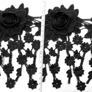 Close-up detail of black 3D floral water-soluble lace trim with ruler showing dimensions