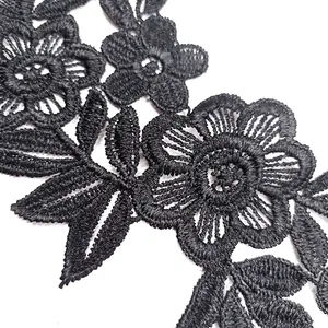 Detailed macro shot of black water-soluble floral lace embroidery applique for DIY