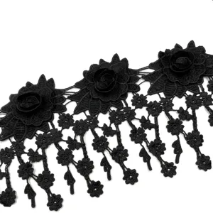 Close-up of black 3D water-soluble lace trim with intricate floral embroidery and tassels