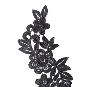 Macro view showing the intricate texture of black floral lace embroidery applique